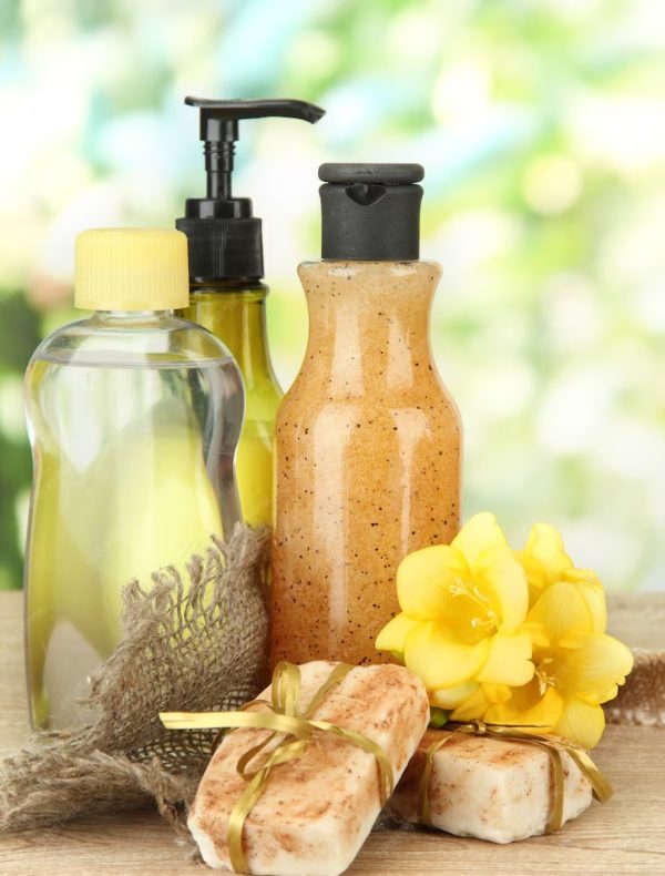 liquid-hand-made-soaps-wooden-table-green-background_392895-18305